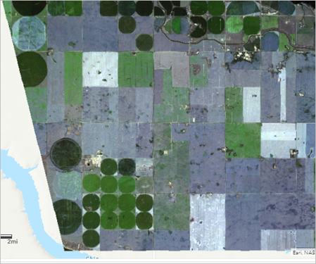 Bare soil displayed in blue-gray tones in the Corn Fields Before Storm image.