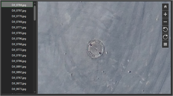 The utility hole cover in DJI_0784.jpg