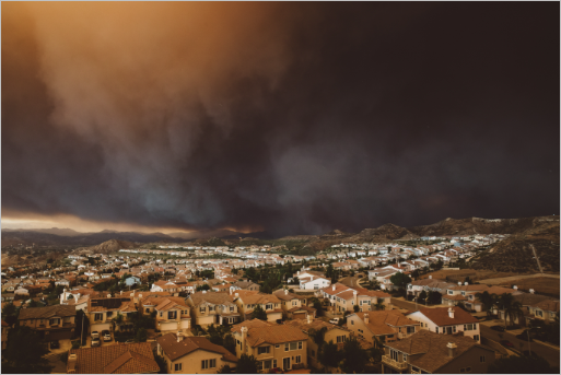 A smoke-filled sky over a suburban neighborhood