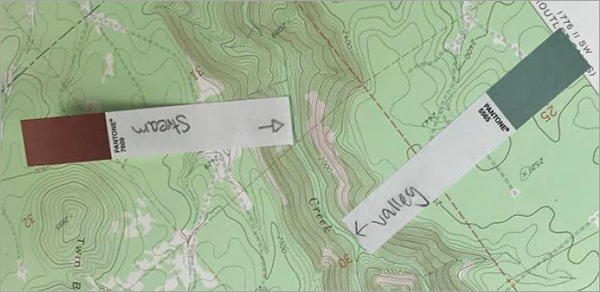 Sticky notes labeling landforms on a topographic map